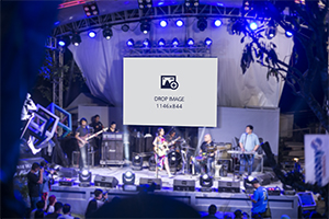 Wide billboard hanging on top of the stage during a concert gig